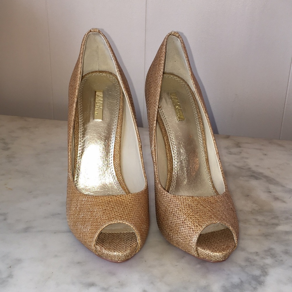 Gold canvas stiletto heeled red bottomed shoes.